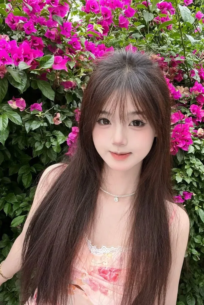 Ảnh gái xinh đẹp dịu dàng tạo dáng bên dãy hoa